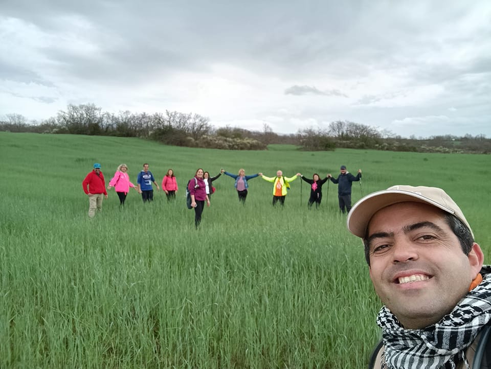 Grupo de caminheiros em campo durante atividade de turismo de natureza