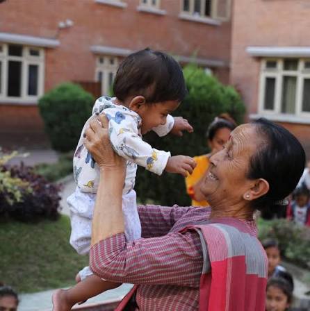 Woman lifting a baby