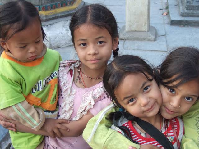 Four children huddled together