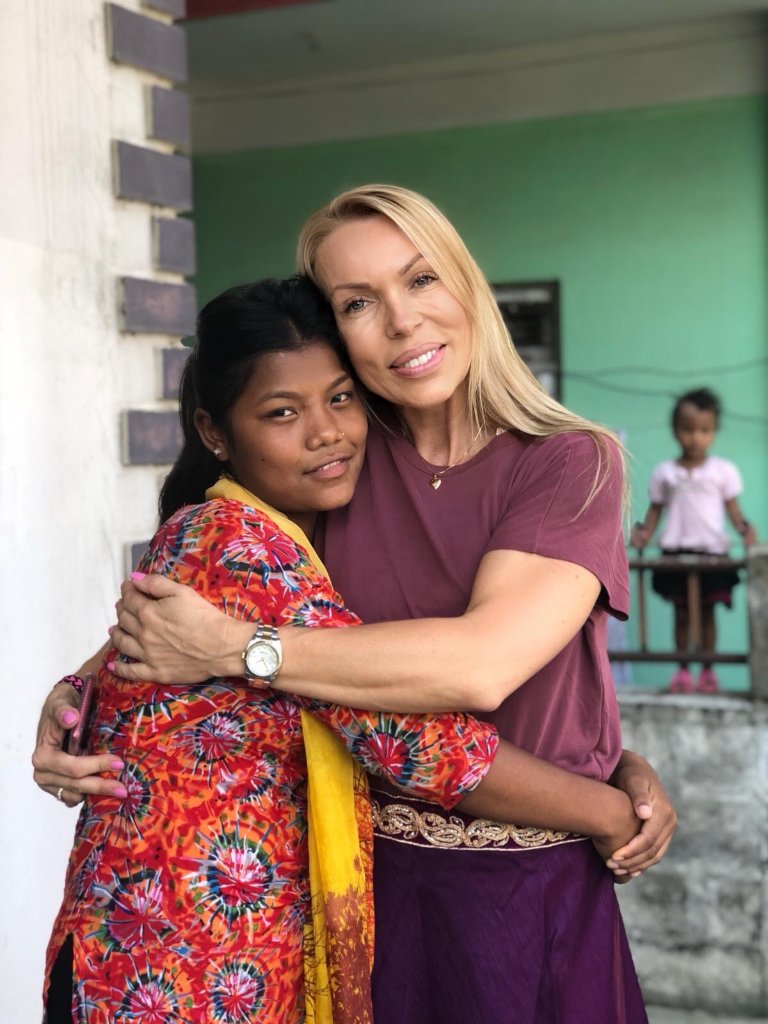 Marianne embracing a child at Maiti Nepal
