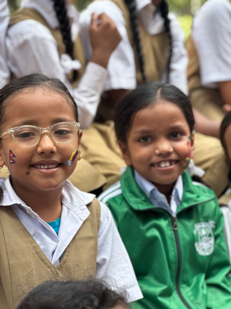 Two students with Nepali flag face paint