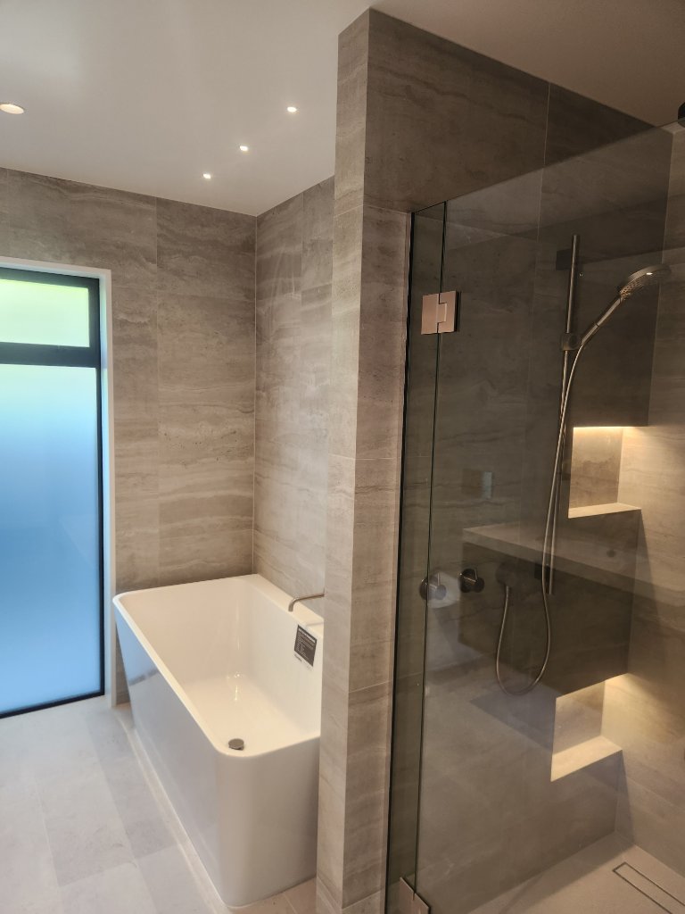 Ensuite bathroom with freestanding bath and shower lighting