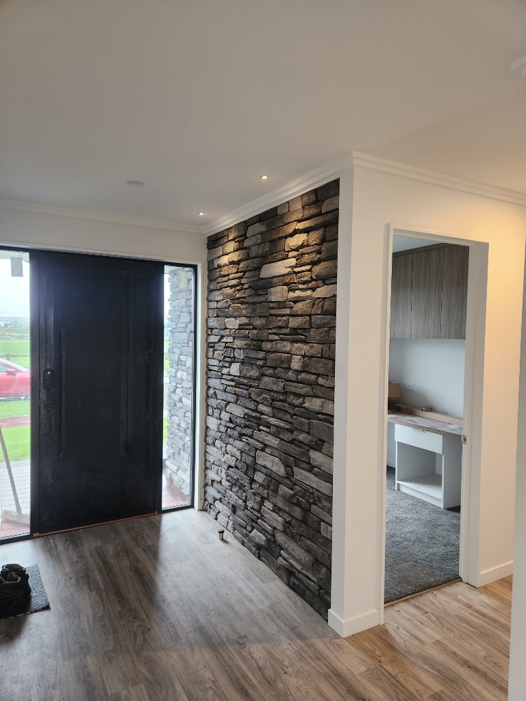 Entryway with stone feature wall and downlights