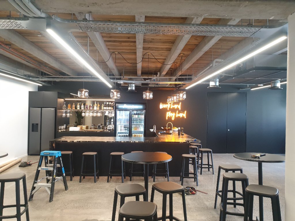 Bar area with pendant lighting and neon sign