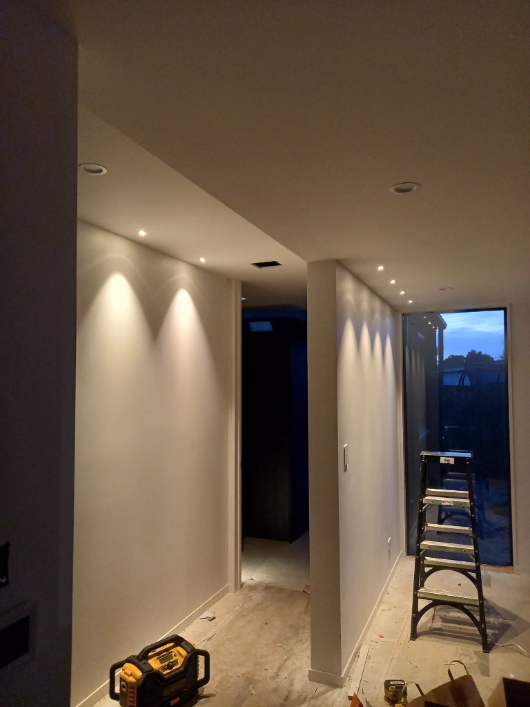 Hallway with wall wash lighting during renovation
