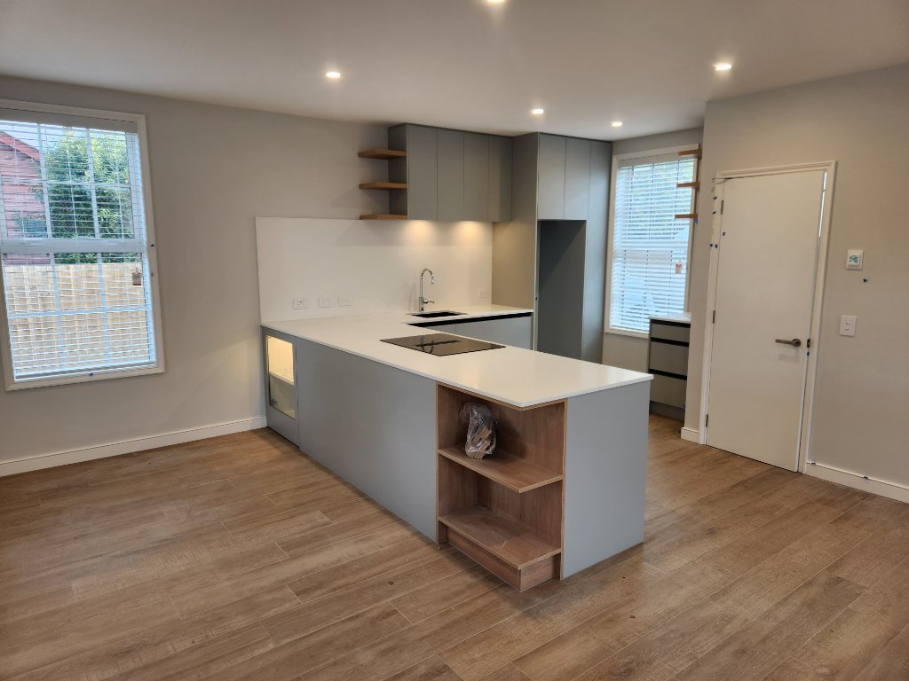 Grey kitchen with timber shelving