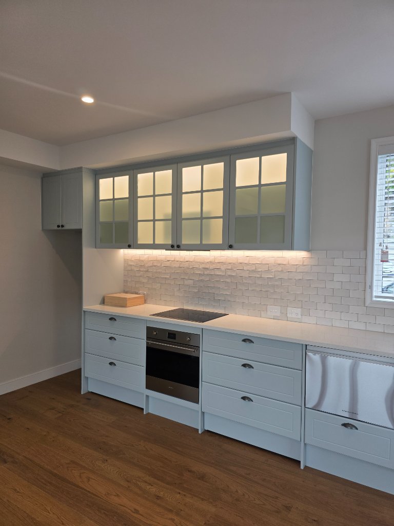 Blue kitchen cabinetry with LED lighting