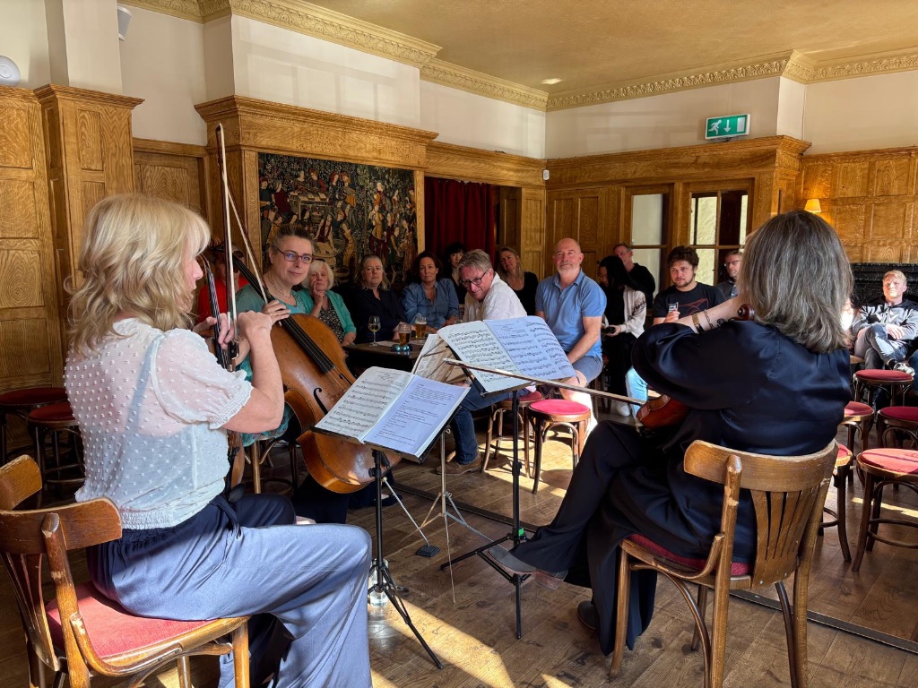 String quartet performing at the Lamb and Flag with audience