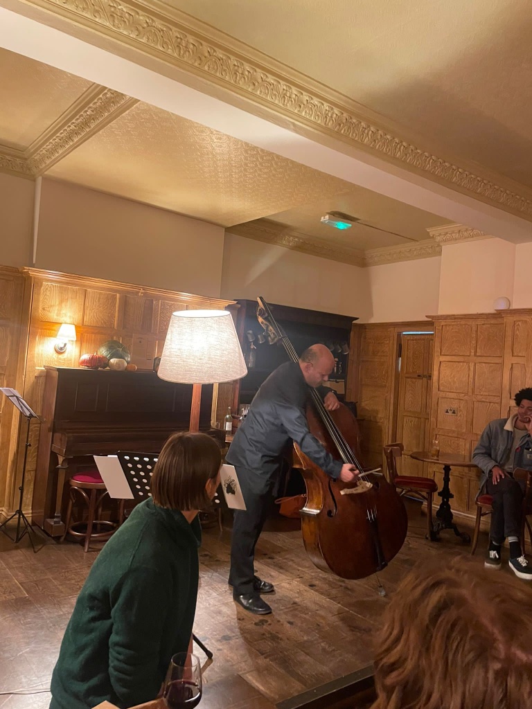 Double bass player performing up close to the audience at Tinklings
