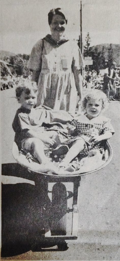 Julian with his mother and sister at the Fourth of July parade, a black and white family photo