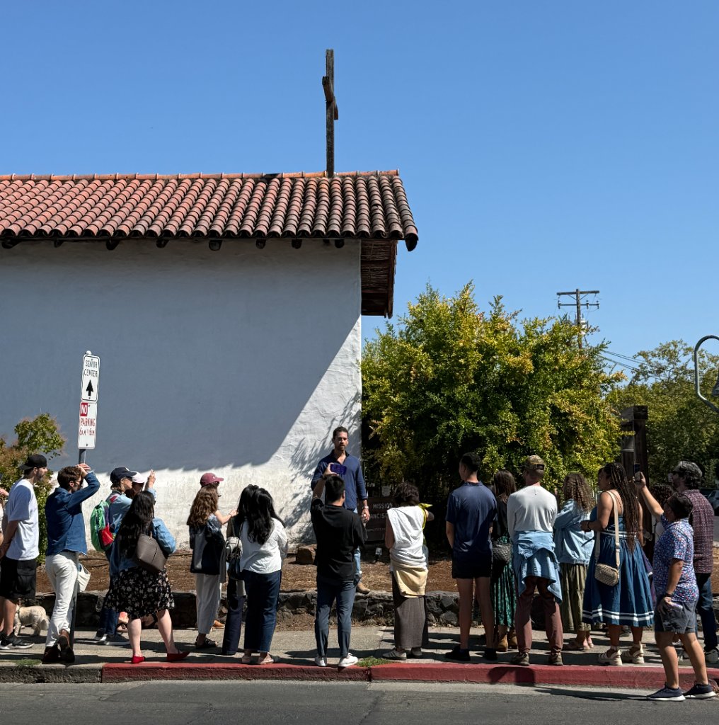 Julian leading a neighborhood walking tour in front of the Sonoma Mission