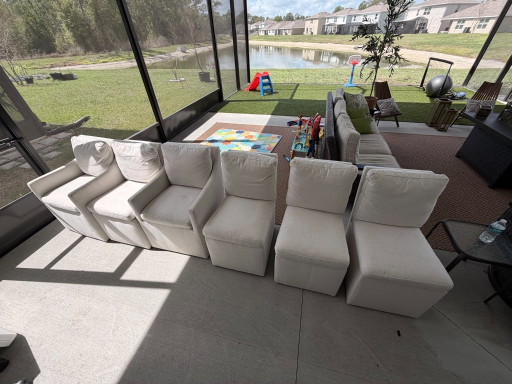 Upholstered chairs lined up for professional cleaning on screened lanai by HydroLux
