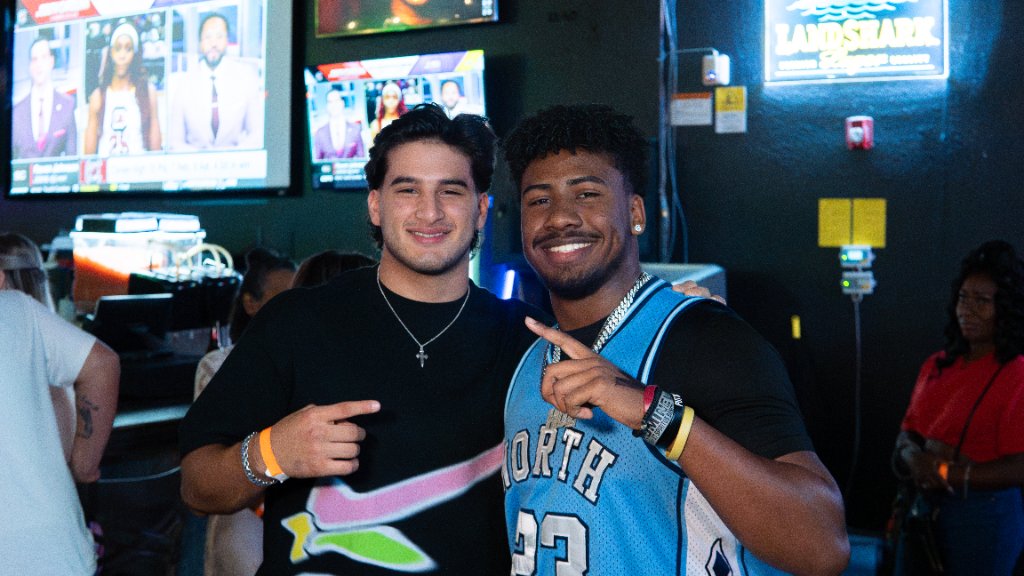 Two guests smiling inside Shorty’s Icehouse