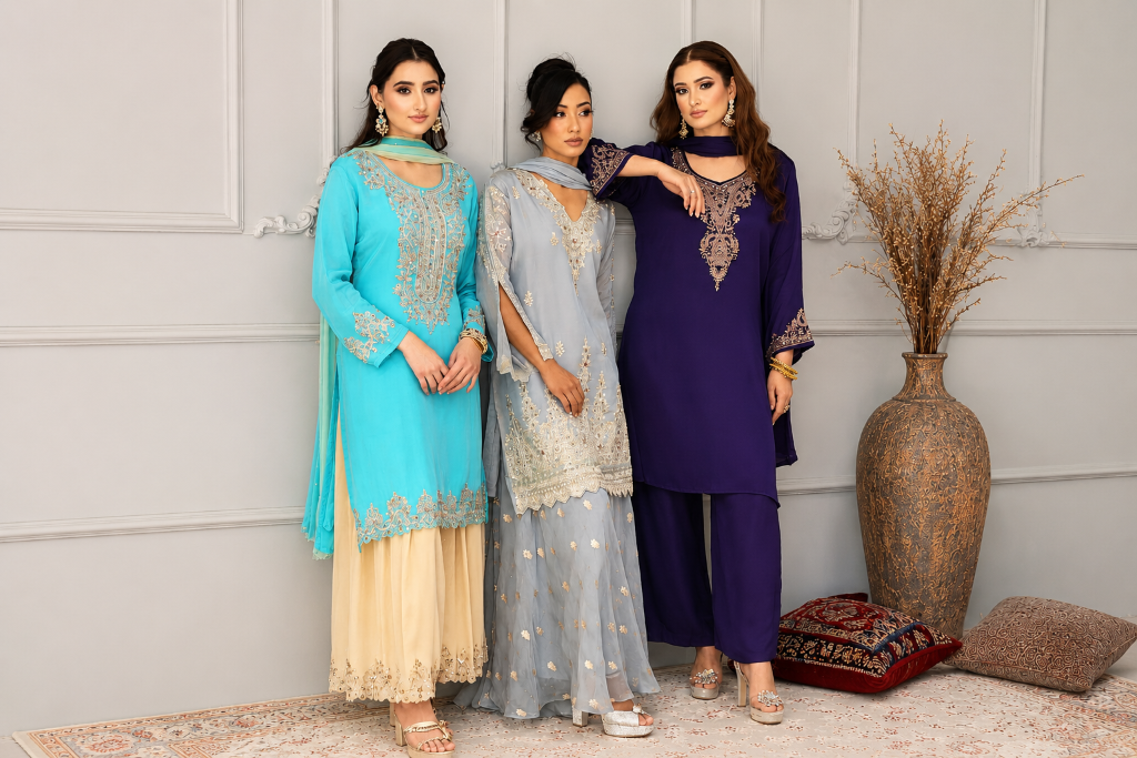 Three models in embroidered occasion wear β turquoise, dusty blue and navy ensembles