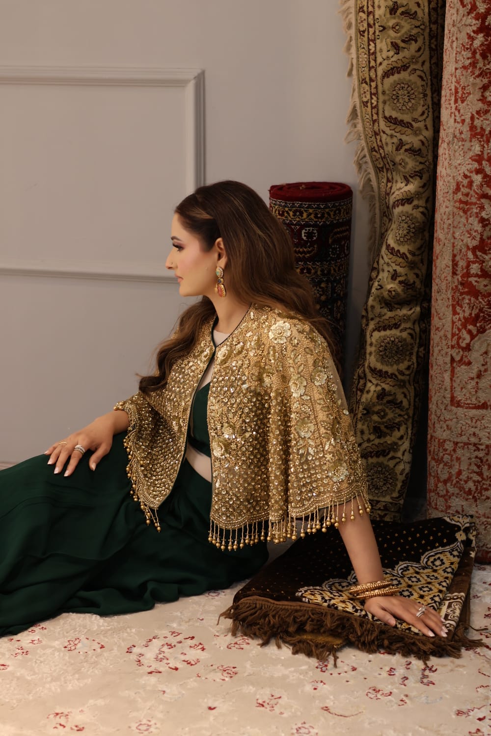 Close-up of intricate gold zardosi embroidery on crimson silk