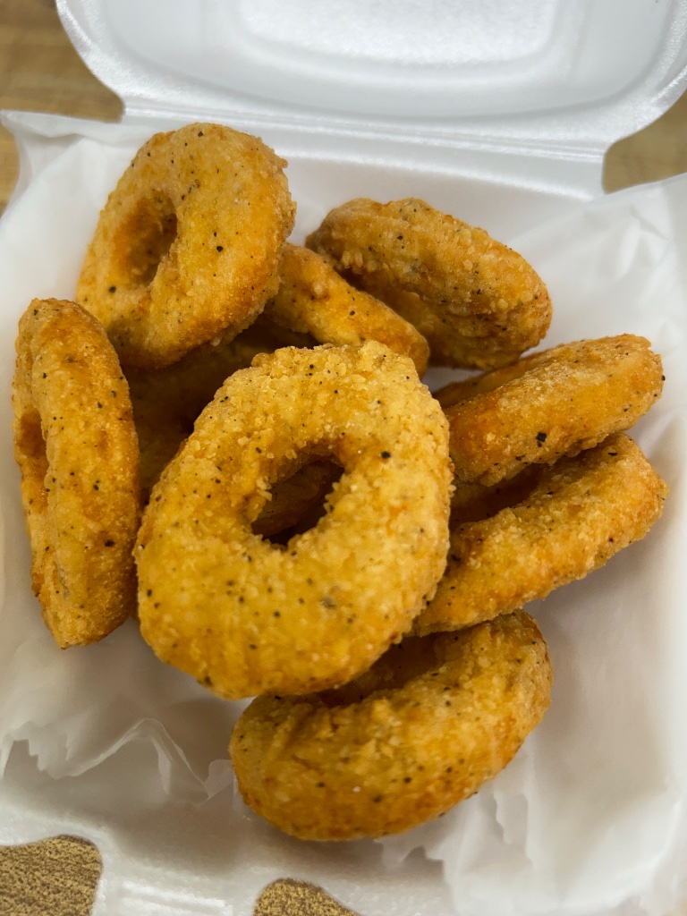 Breaded onion rings in a to-go box
