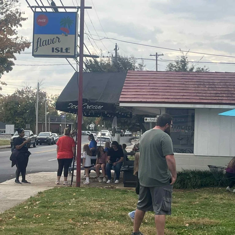 Community walk group holding milkshakes under the sign