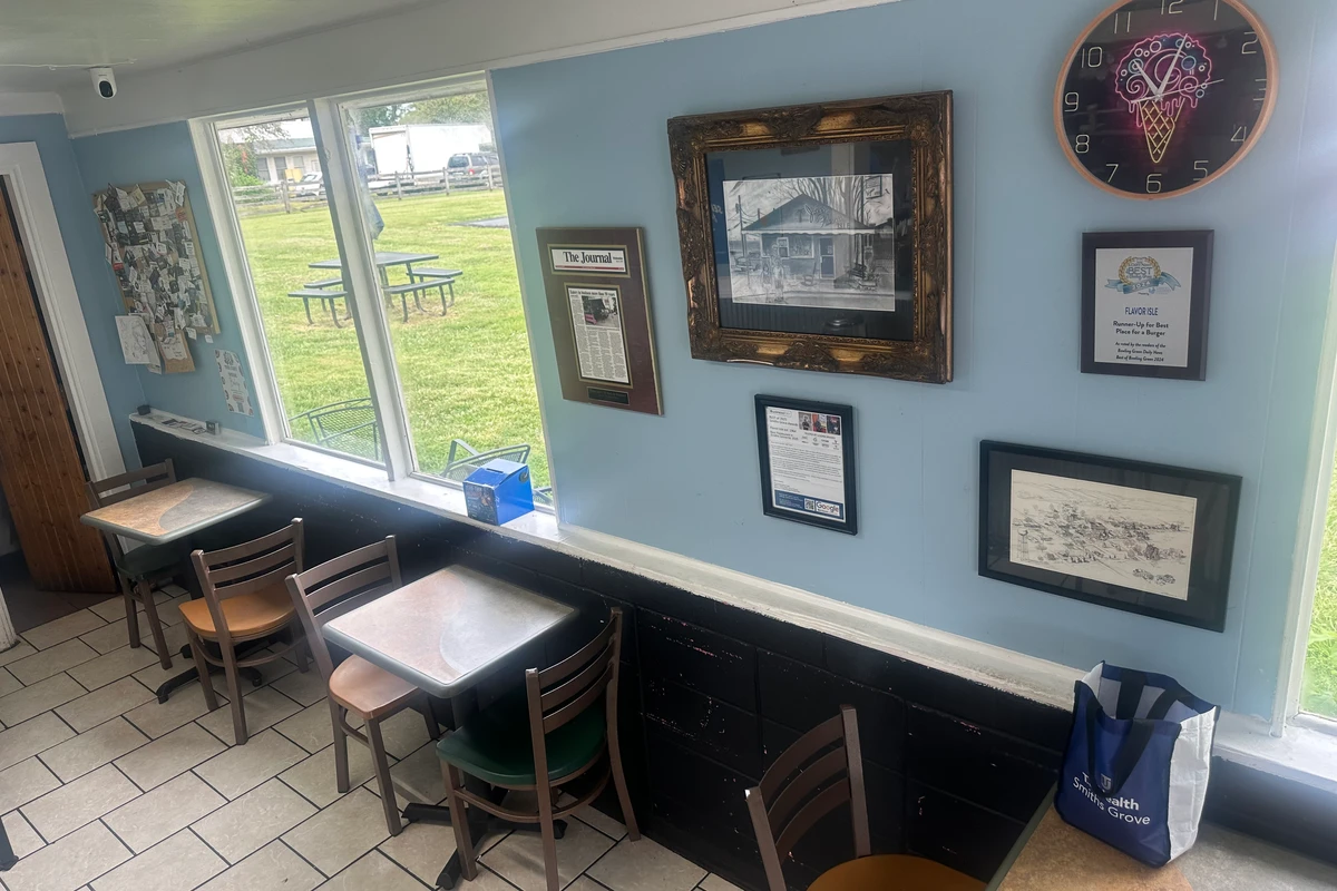Flavor Isle dining room wall with framed local history and awards