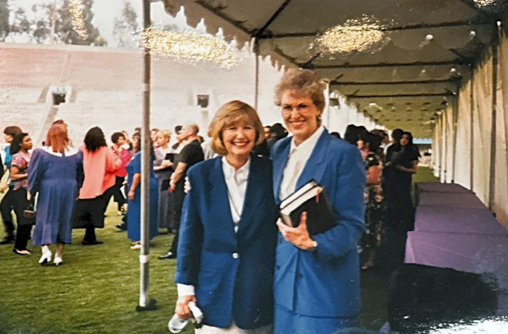 Two women in matching blazers on the Rose Bowl field