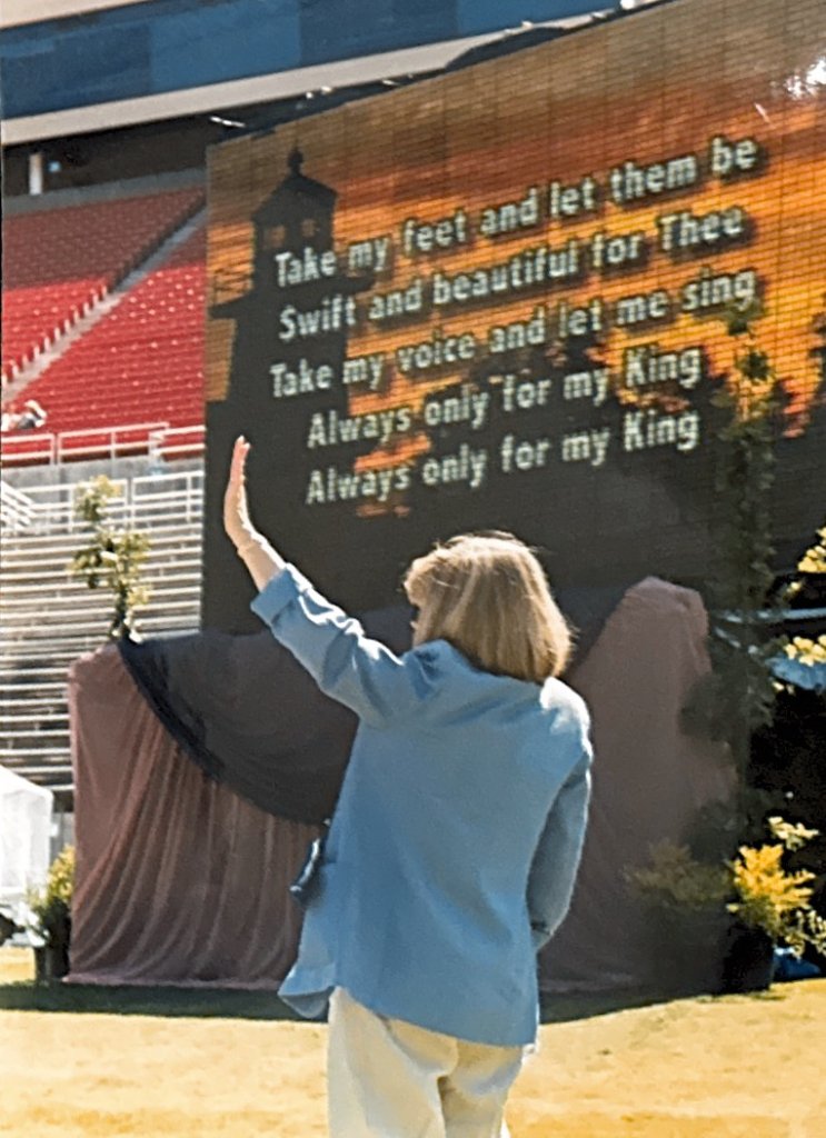 Worshippers with hands raised in the stands