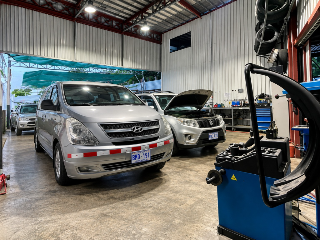 Natural Car Rental vehicles in the maintenance area.