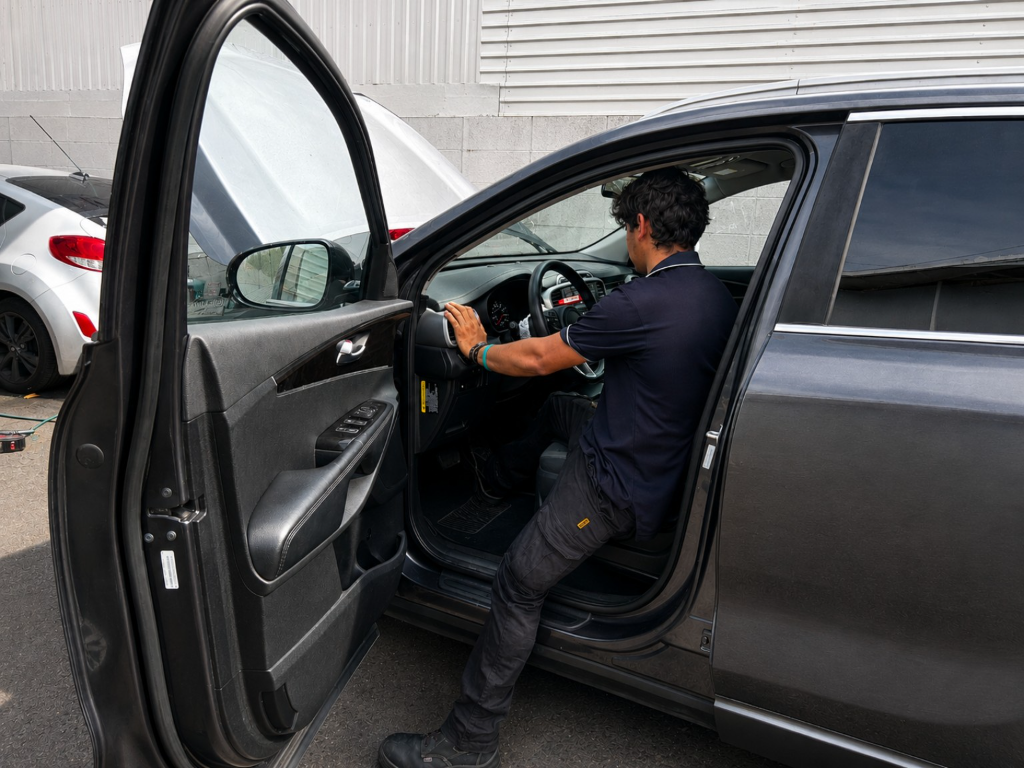 Team member checking the interior of a vehicle.