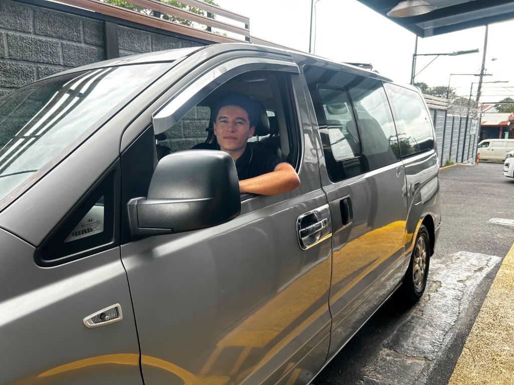 Minibus used in Natural Car Rental transportation operations.