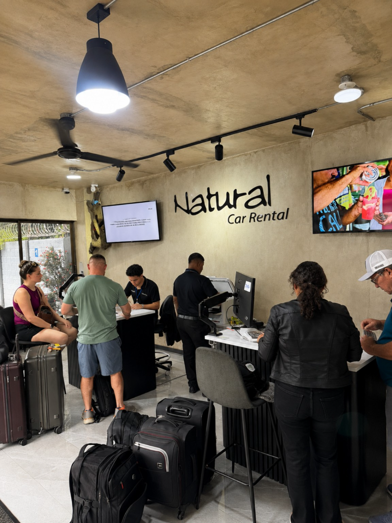 Customers being assisted at the Natural Car Rental office.