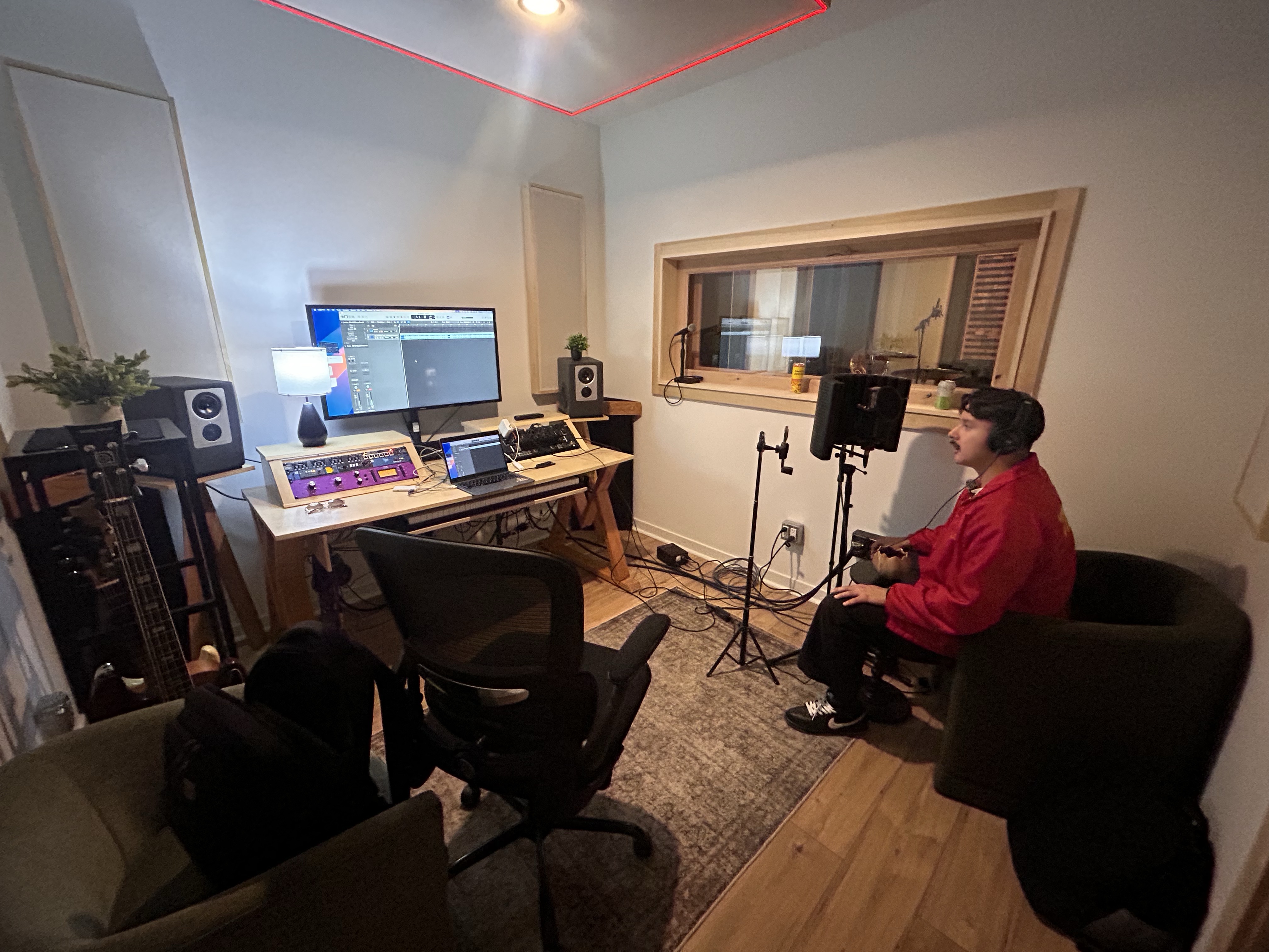 Artist recording vocals in the treated studio room