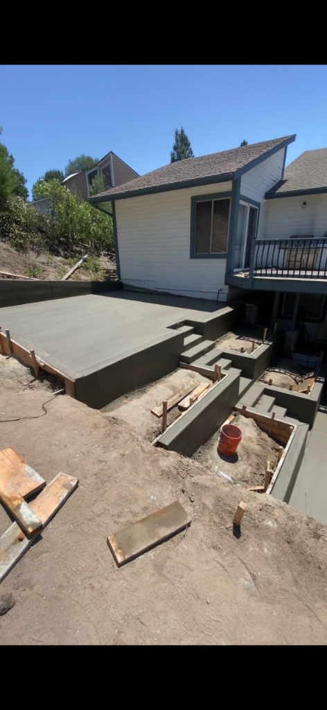 Elevated multi-tier concrete patio with stepped design under construction