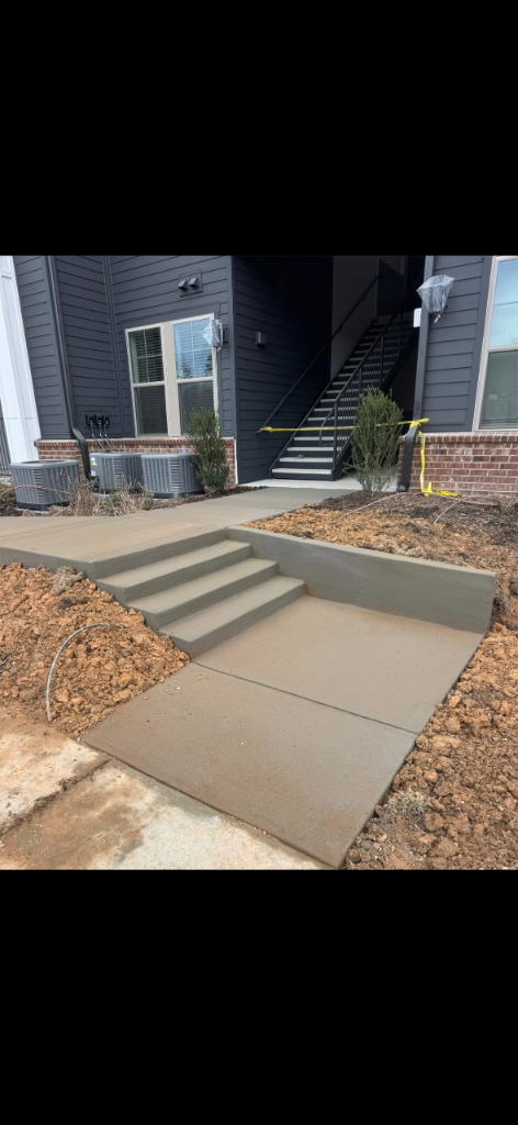 Newly finished three-step concrete landing and stairway with caution tape in front of a residential building