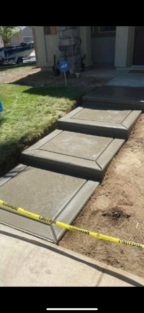 Custom molded concrete entry steps with decorative border detail