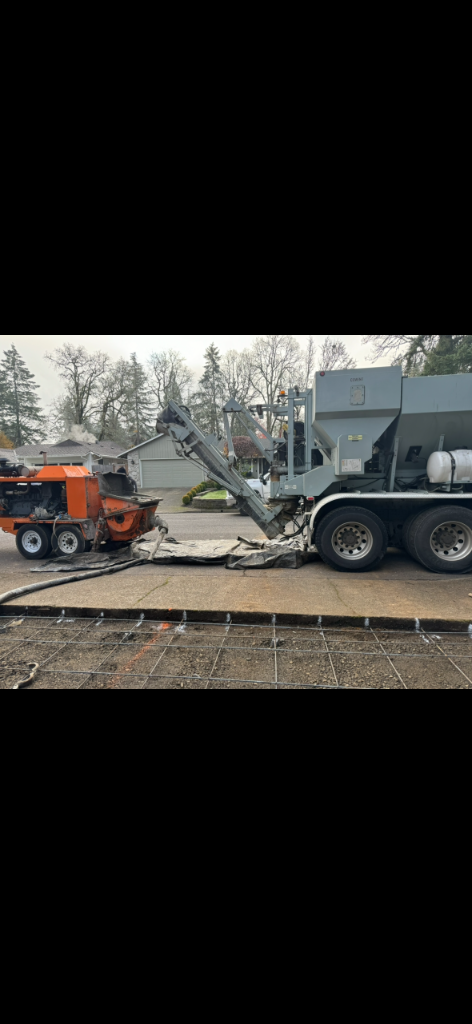 Concrete pump truck and portable pump connected over rebar mesh grid at residential site