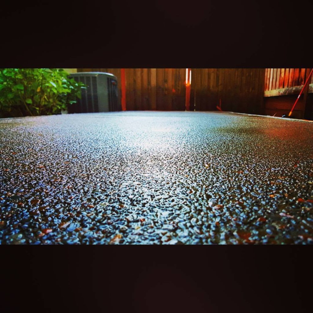 Exposed aggregate concrete surface with gloss sealed finish