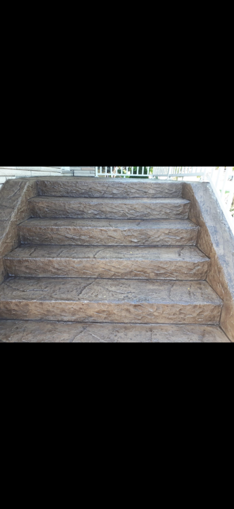 Faux stone stamped concrete entry steps with mottled brown texture