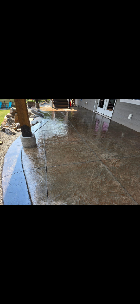 Dark brown stamped concrete patio with curved decorative border edge
