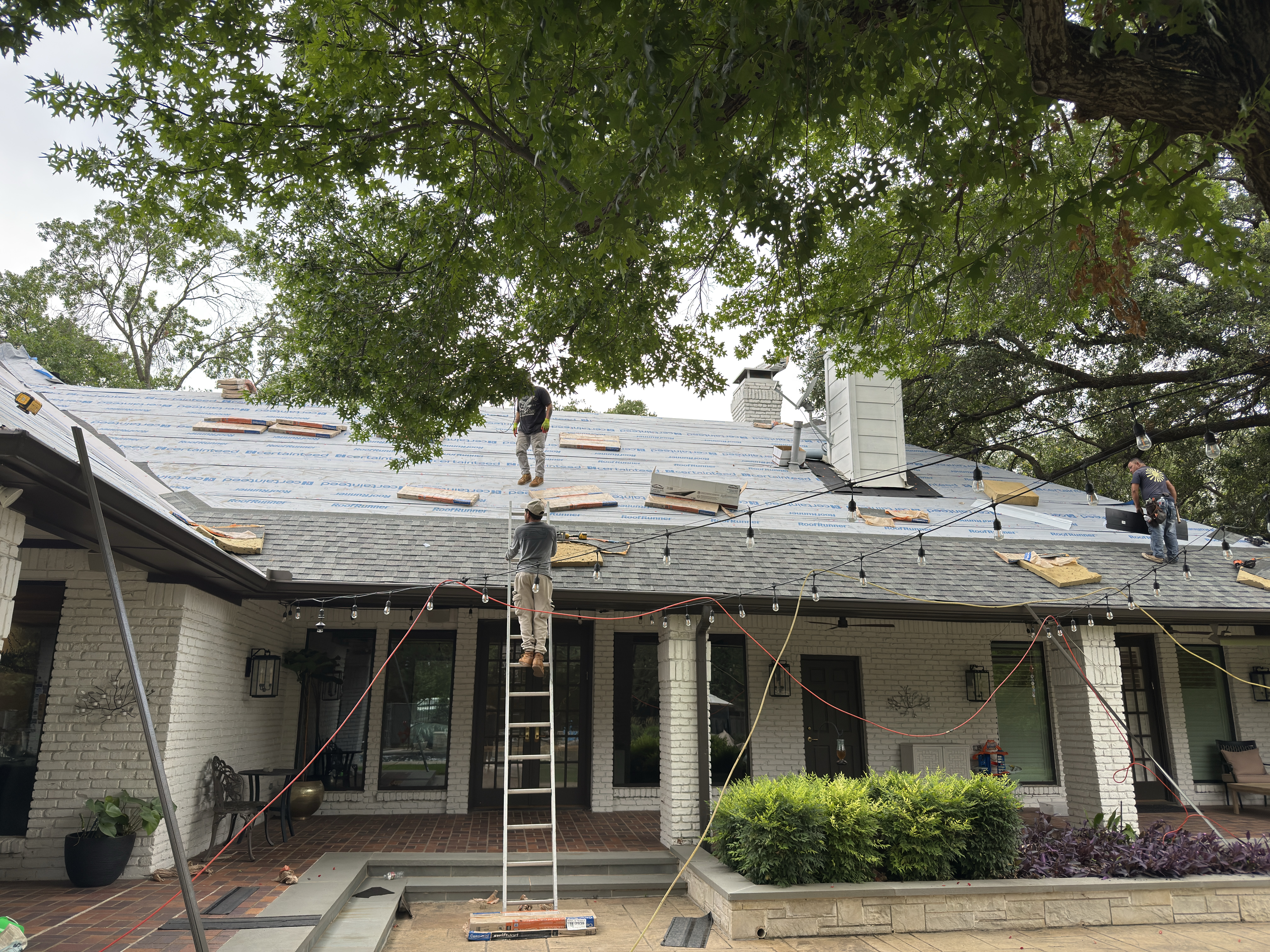 Roof Pros Dallas crew working together on a residential roof replacement