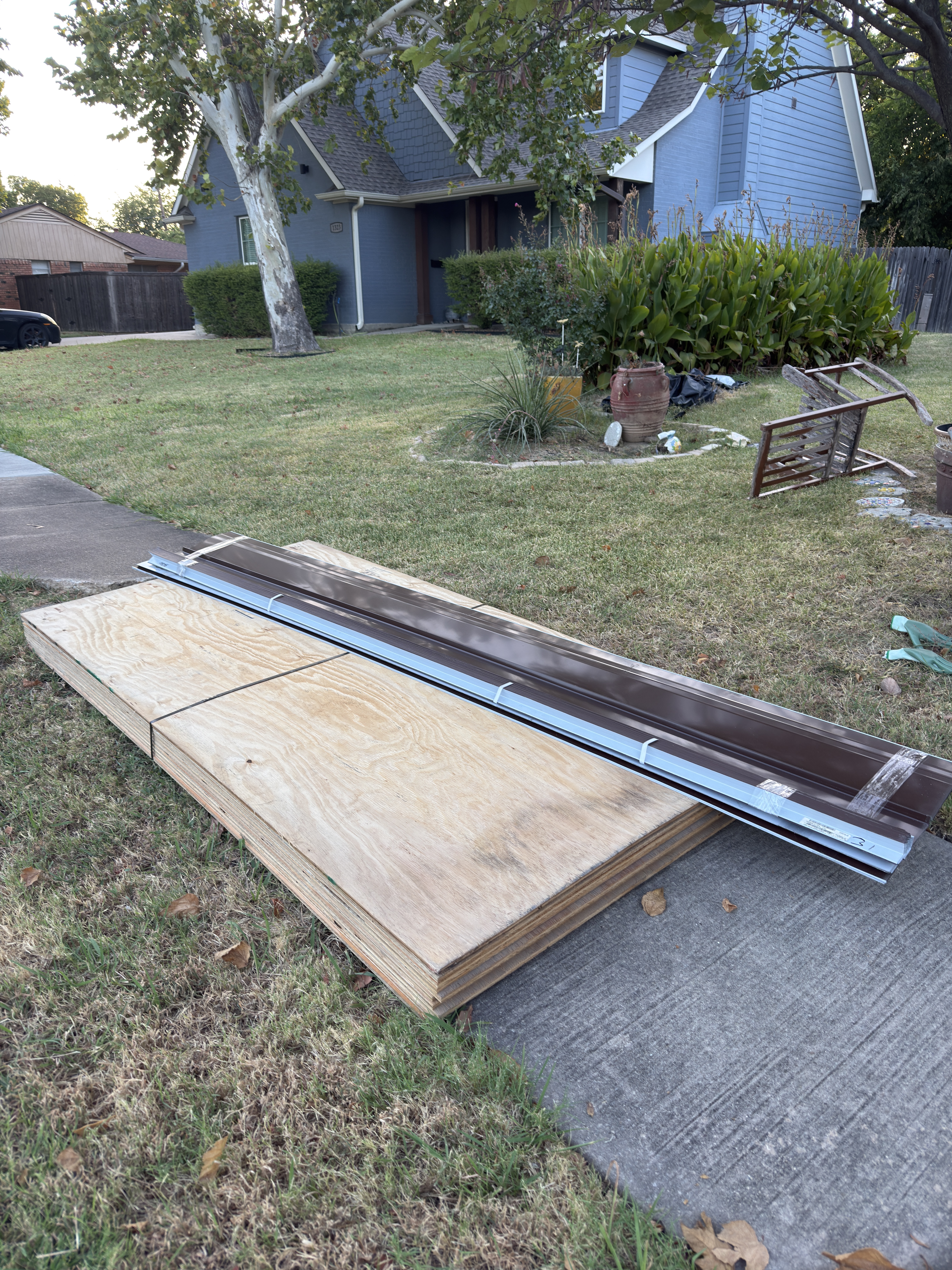 Plywood decking and metal drip edge staged for a roofing project by Roof Pros Dallas