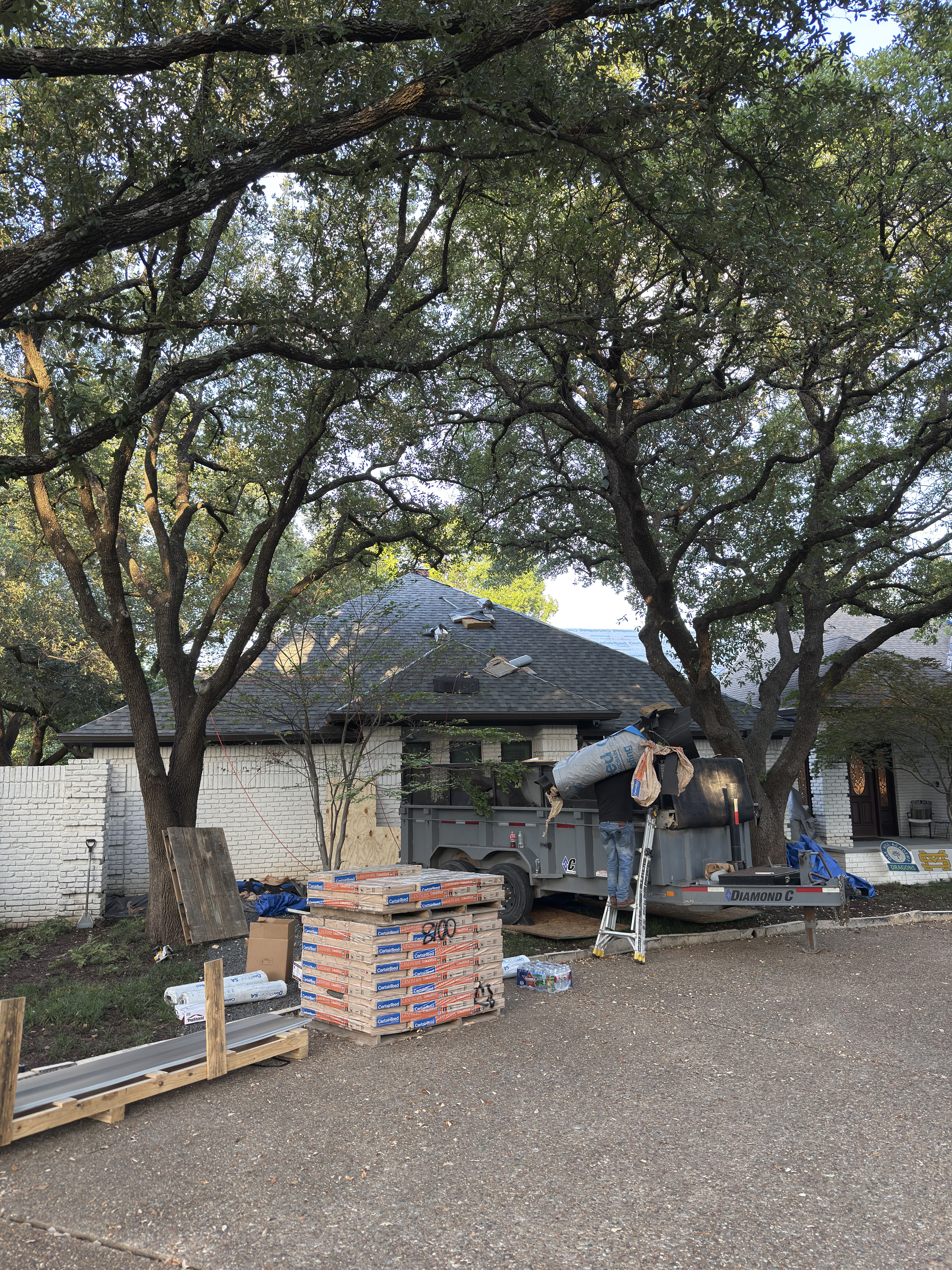 Shingle delivery and staging during a residential roof replacement by Roof Pros Dallas