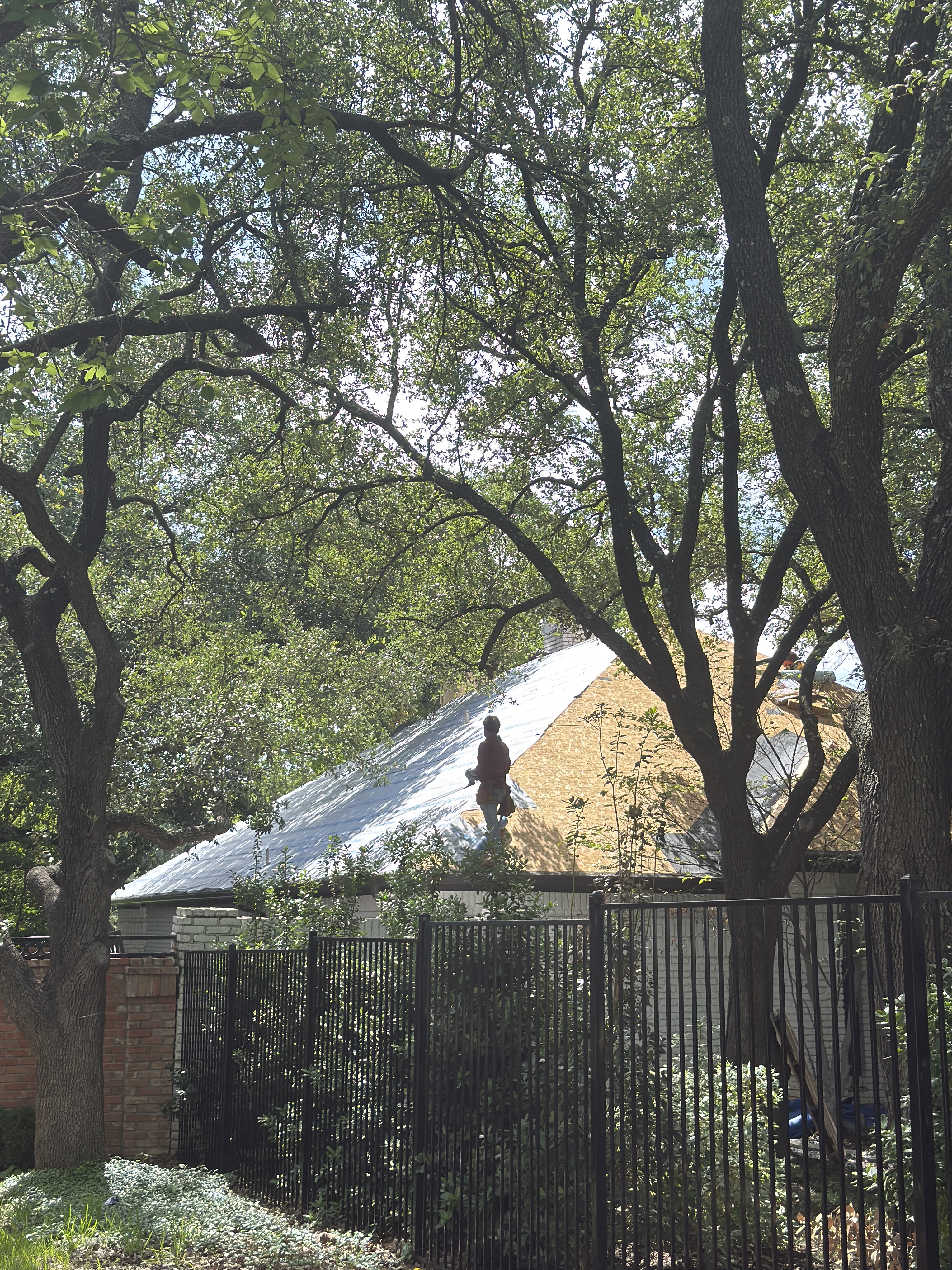 Roof Pros Dallas crew working on the roof deck during a residential replacement project