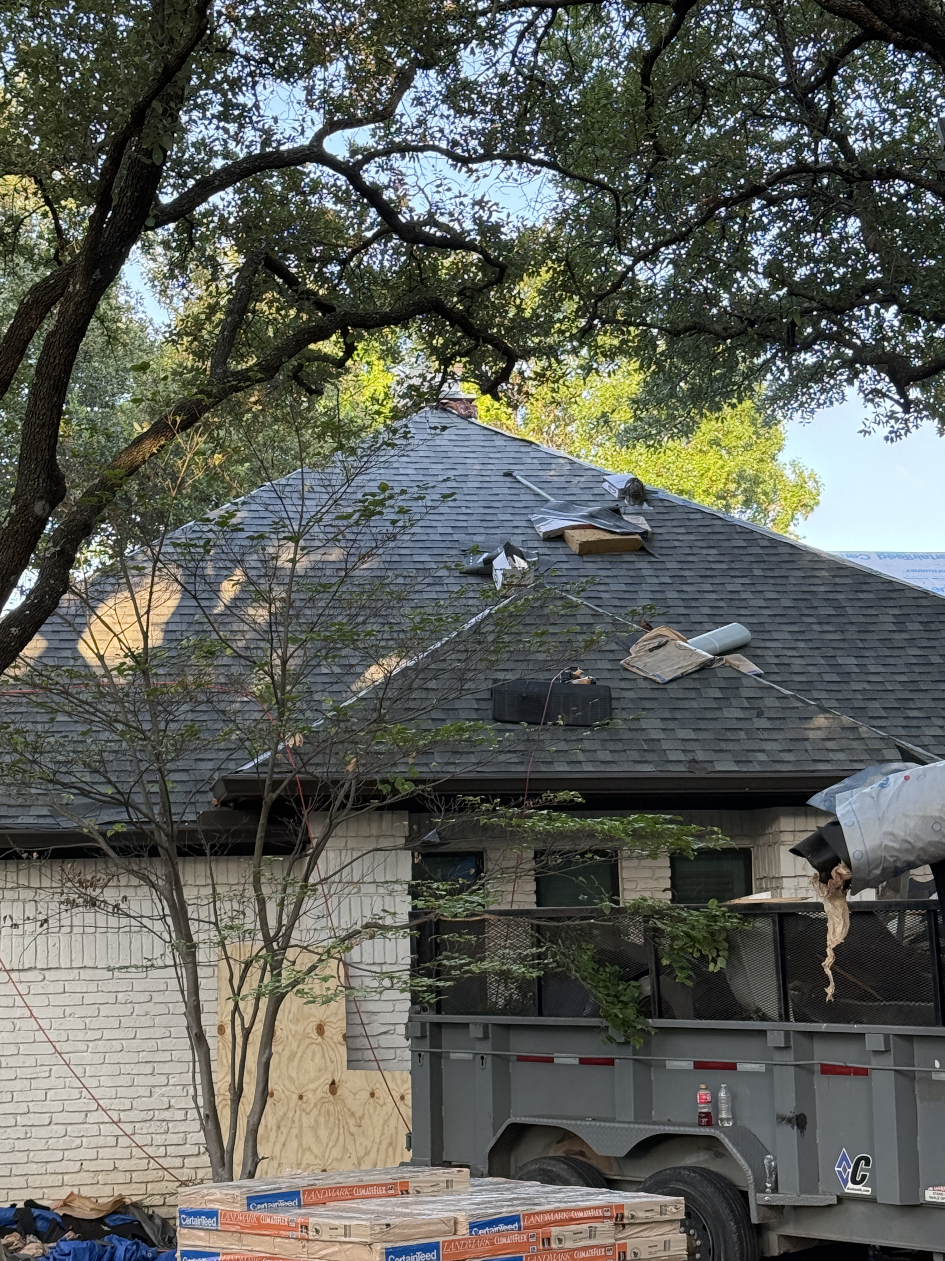 Residential hip roof replacement in progress with new architectural shingles by Roof Pros Dallas