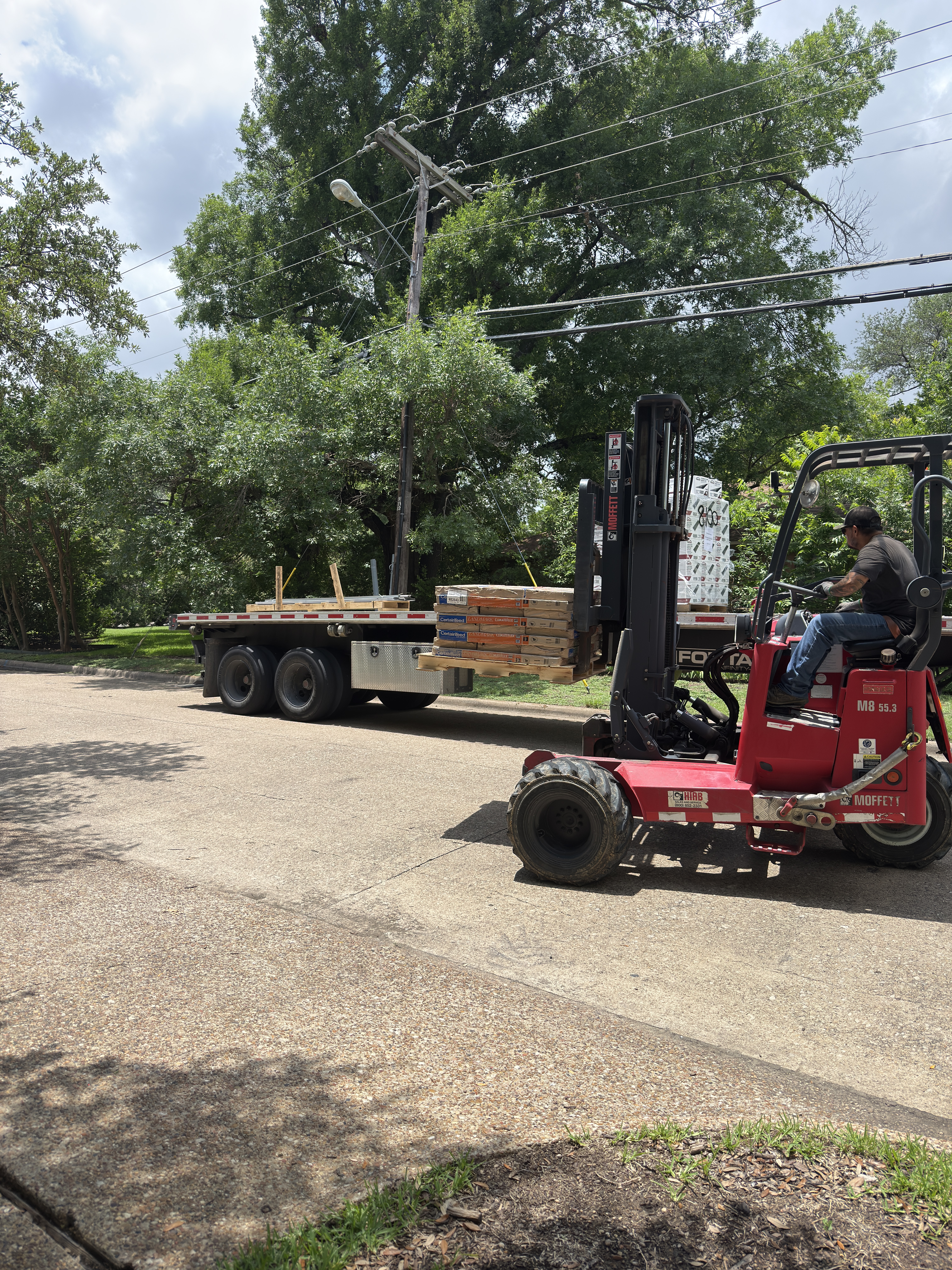 CertainTeed shingle delivery by forklift on a Roof Pros Dallas residential roof replacement