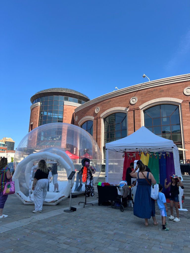 Guests inside IMAGICA inflatable bubble dome with confetti at outdoor summer event Brampton