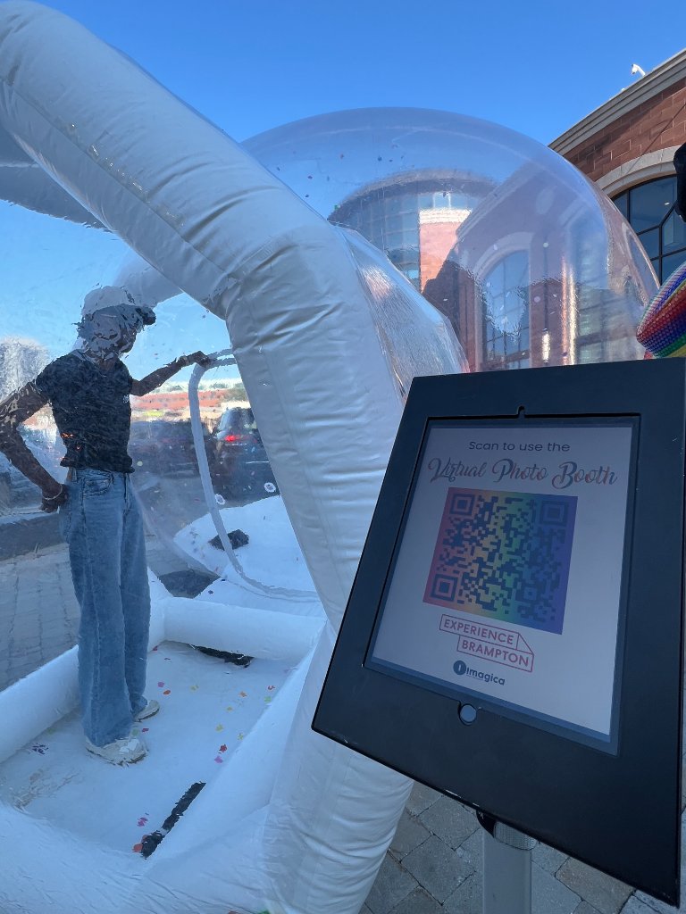IMAGICA Virtual Photo Booth QR code kiosk at Brampton Pride 2026 with inflatable bubble dome