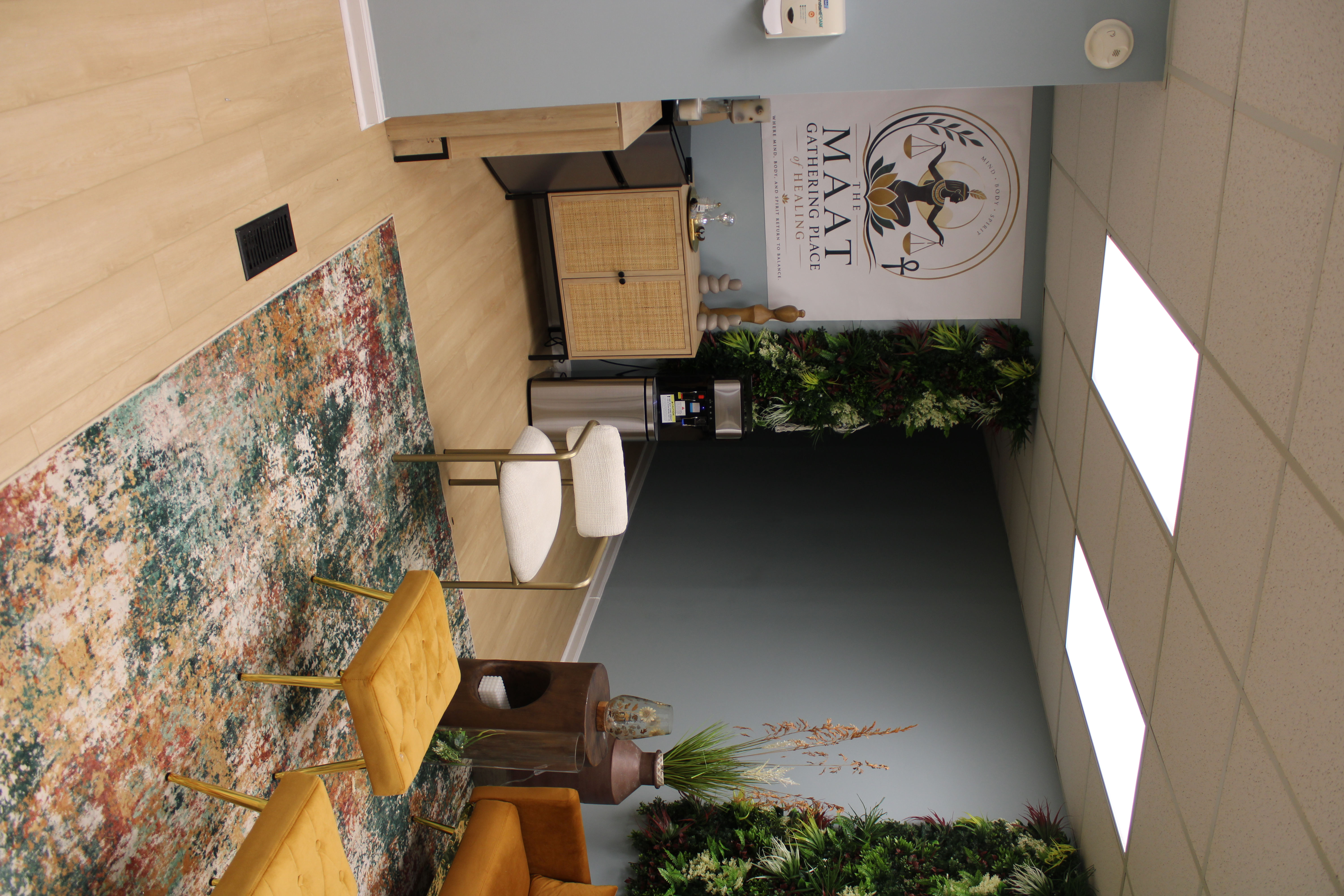 MAAT welcome lounge with the MAAT logo and living wall