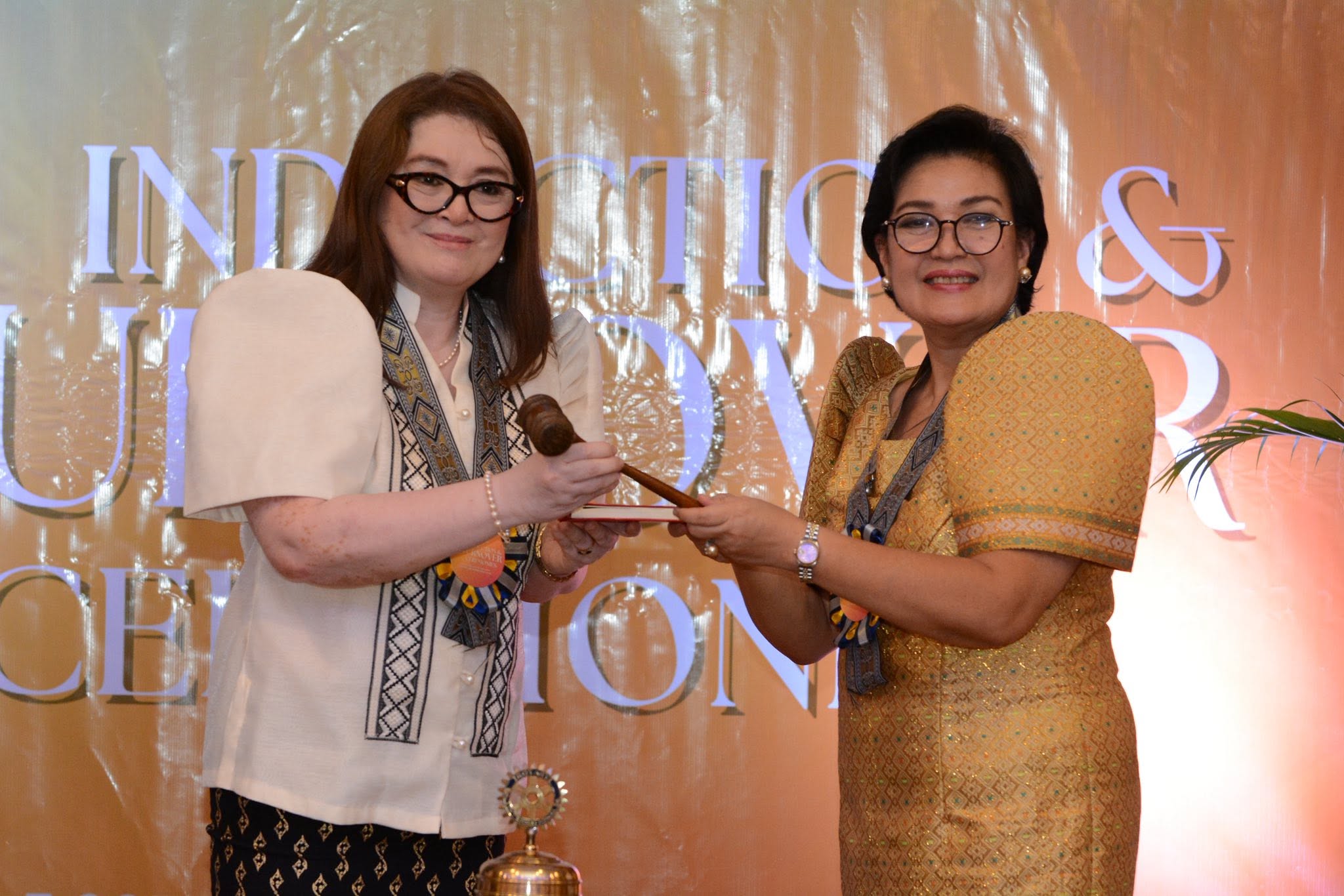 Ma. Emma Azcaragga Ramas holding a ceremonial gavel