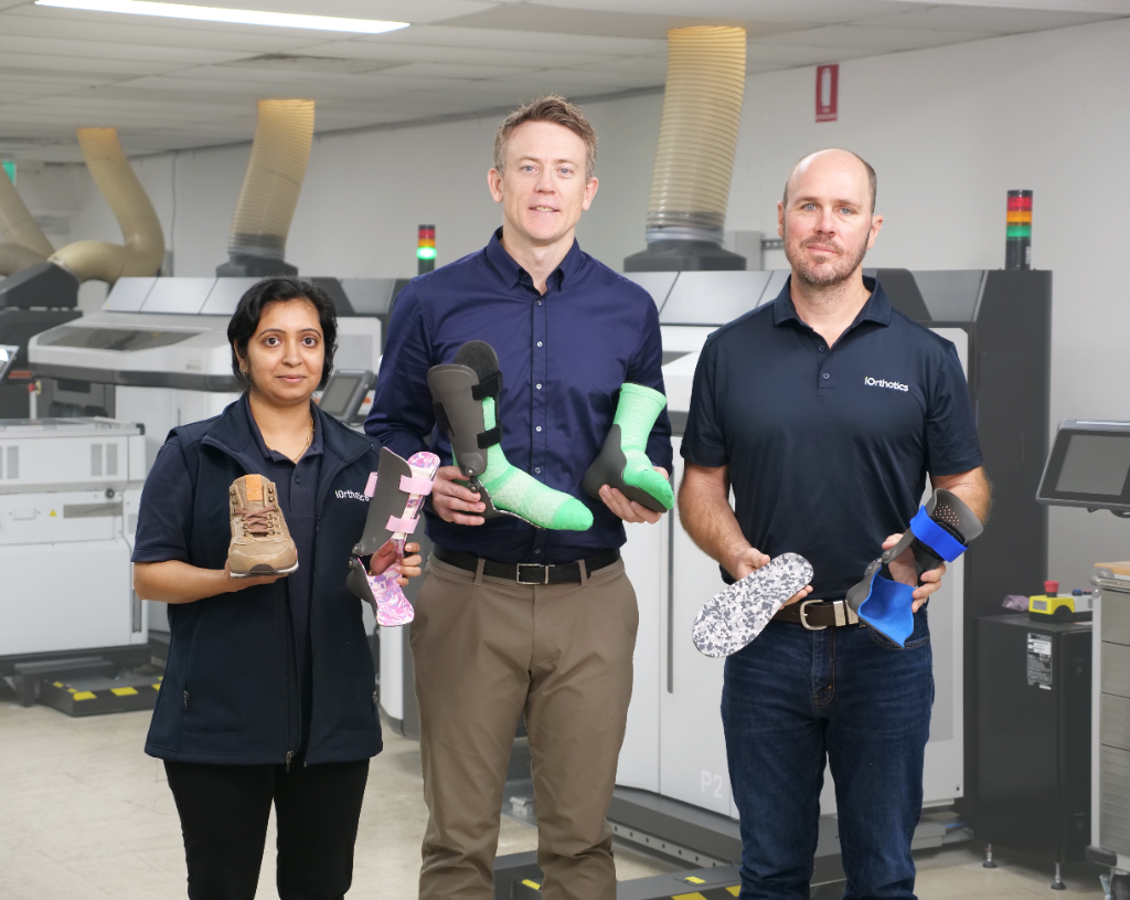 The iOrthotics clinical team standing in the print room