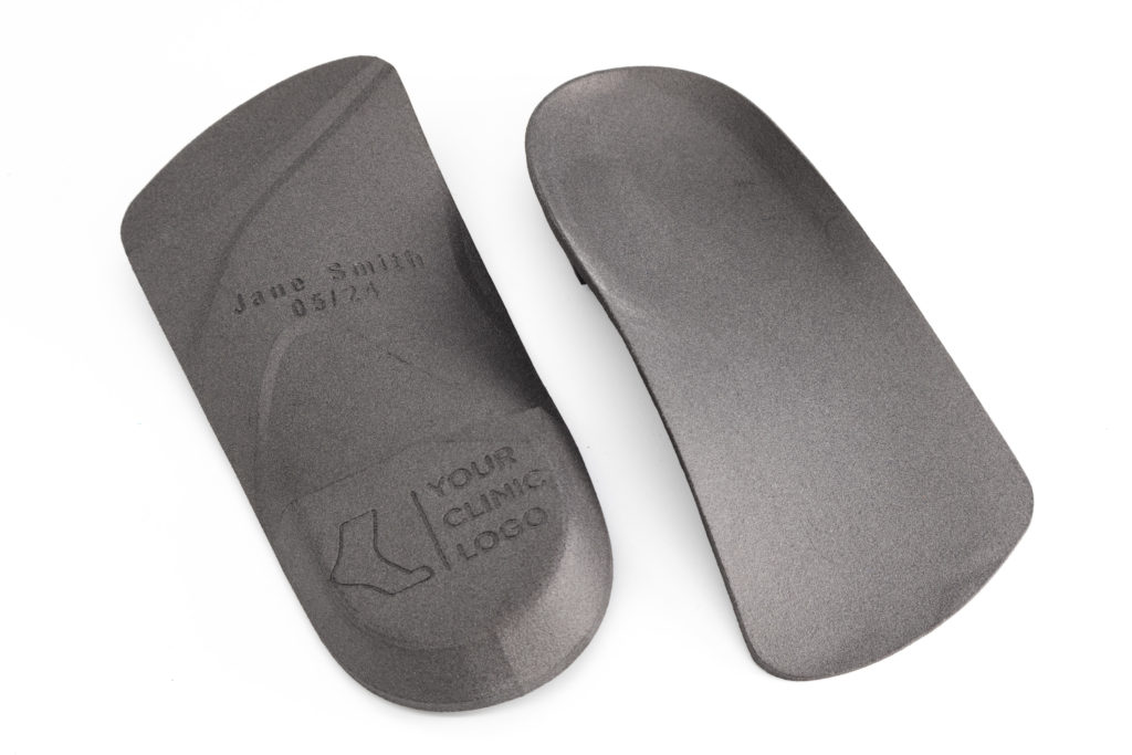 Pair of bare 3D-printed orthotic shells on white
