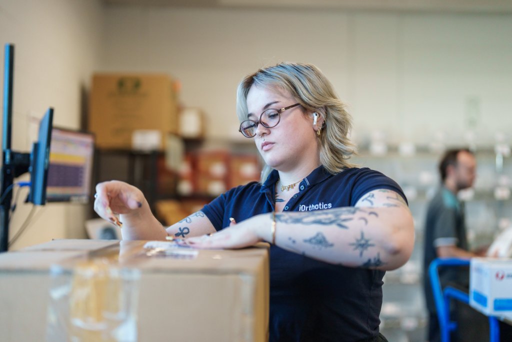 iOrthotics team member preparing orthotic devices with care