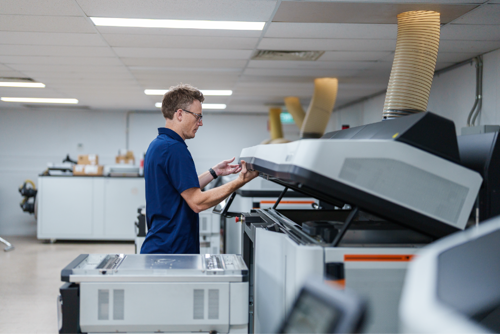 An iOrthotics technician operating an HP Multi Jet Fusion 3D printer